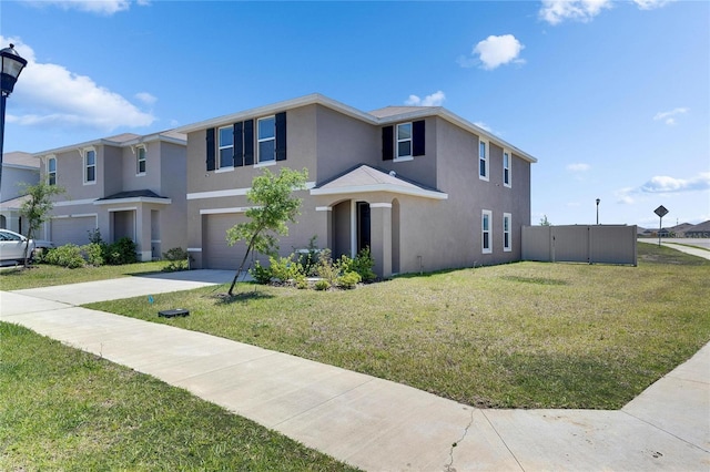 view of front of house with a garage, a front yard, driveway, and stucco siding
