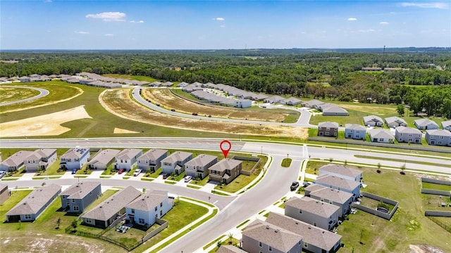 birds eye view of property with a wooded view and a residential view