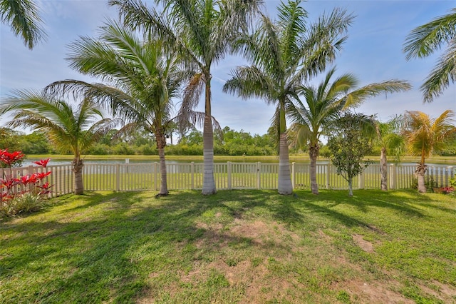 view of yard featuring a water view and fence