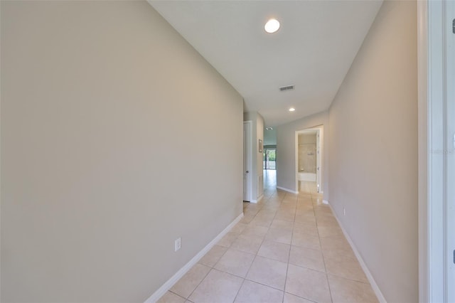 hall featuring recessed lighting, baseboards, visible vents, and light tile patterned floors