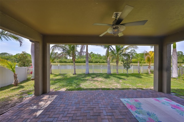 view of patio / terrace featuring a ceiling fan, a fenced backyard, and a water view