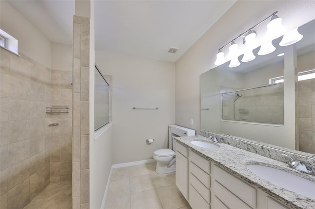 full bathroom featuring toilet, walk in shower, a sink, and visible vents