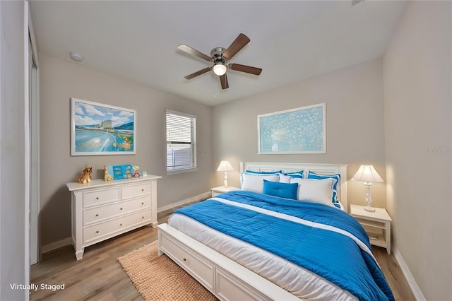 bedroom featuring baseboards, a ceiling fan, and wood finished floors