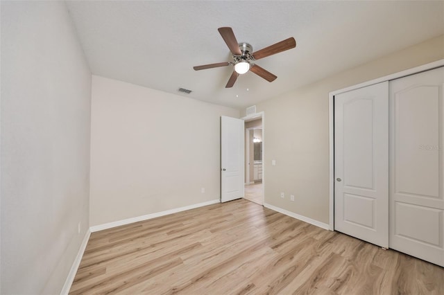 unfurnished bedroom featuring visible vents, light wood-style floors, and baseboards