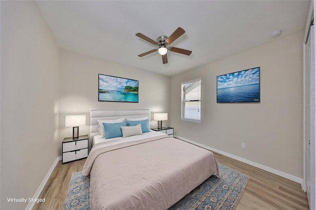 bedroom featuring baseboards, a ceiling fan, and light wood-type flooring