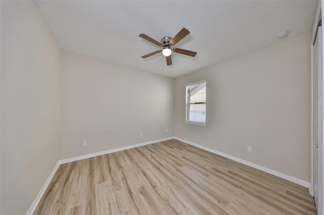empty room featuring baseboards, ceiling fan, and light wood-style flooring
