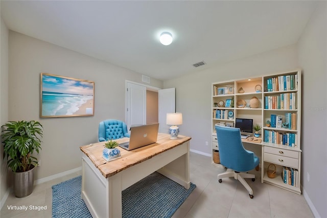 office with visible vents, baseboards, and light tile patterned floors