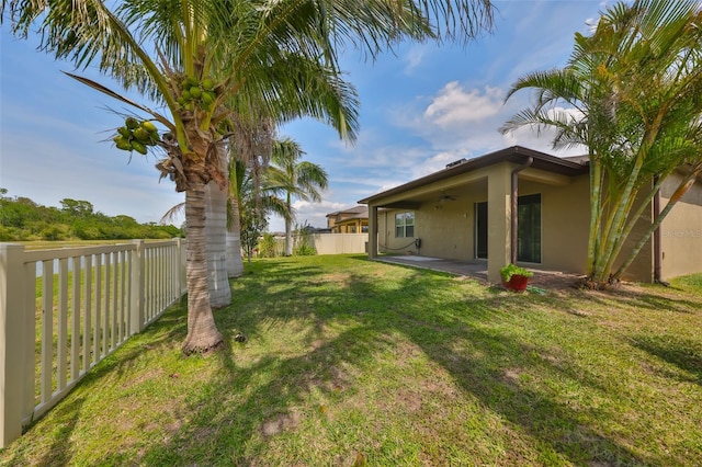 view of yard featuring ceiling fan, a fenced backyard, and a patio area