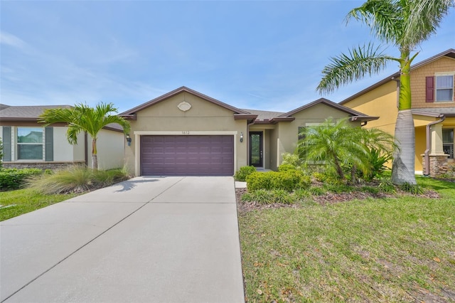 view of front of home featuring an attached garage, driveway, a front lawn, and stucco siding