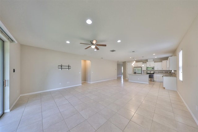 1612 Cabbage Key Dr, Ruskin, FL 33570 - unfurnished living room featuring recessed lighting, ceiling fan, light tile patterned flooring, baseboards, and a sink