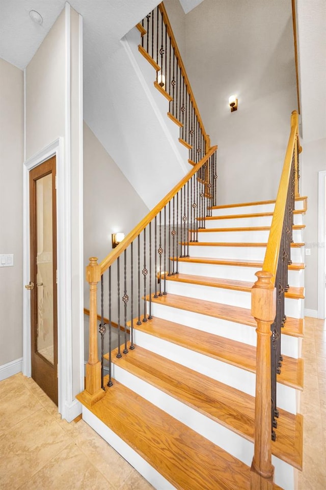47 W Morgan St, Tarpon Springs, FL 34689 - staircase with tile patterned floors and baseboards