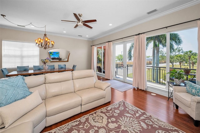 47 W Morgan St, Tarpon Springs, FL 34689 - living room featuring visible vents, crown molding, wood finished floors, ceiling fan with notable chandelier, and recessed lighting