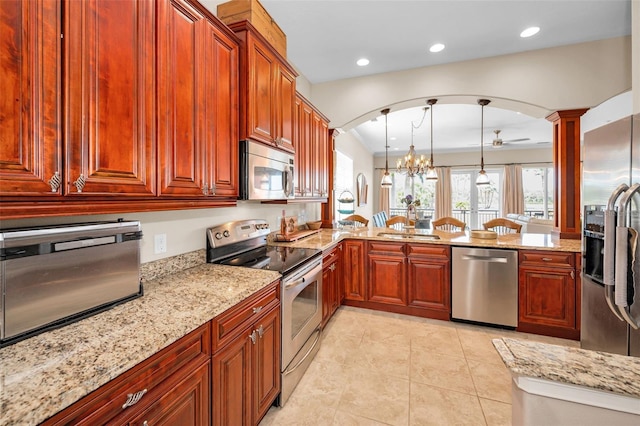 47 W Morgan St, Tarpon Springs, FL 34689 - kitchen featuring recessed lighting, arched walkways, light stone countertops, and stainless steel appliances