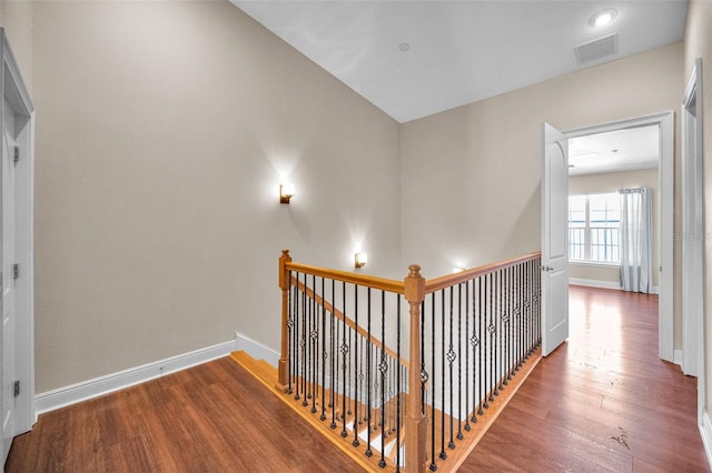 47 W Morgan St, Tarpon Springs, FL 34689 - corridor featuring baseboards, visible vents, wood finished floors, and an upstairs landing