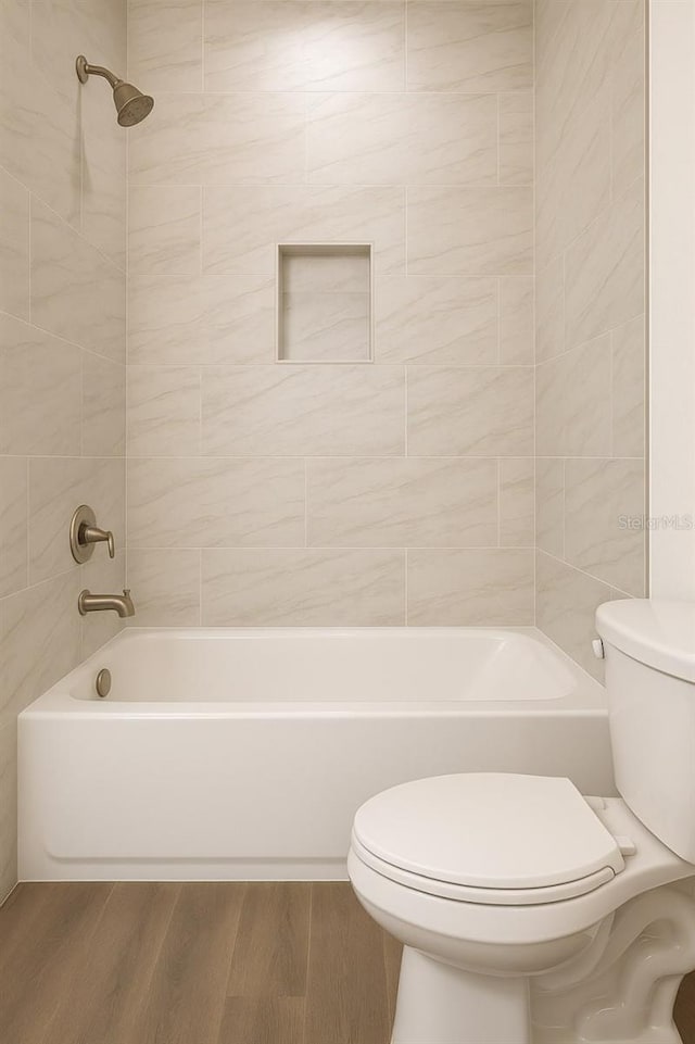 9002 Glenarm Way, Spring Hill, FL 34613 - full bathroom featuring wood finished floors, toilet, and  shower combination