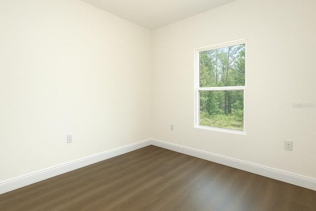 9002 Glenarm Way, Spring Hill, FL 34613 - empty room with dark wood-style flooring and baseboards