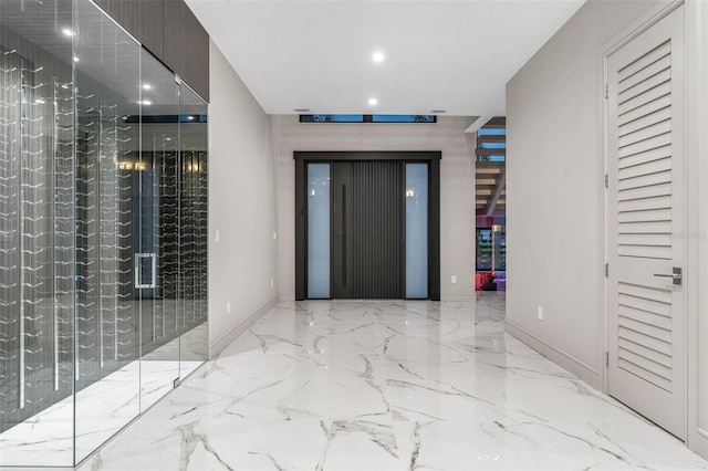 hallway featuring baseboards, marble finish floor, and recessed lighting