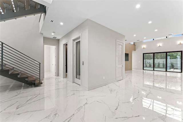 empty room featuring marble finish floor, visible vents, stairs, and recessed lighting