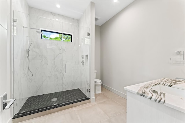 full bathroom with baseboards, a marble finish shower, toilet, tile patterned floors, and vanity