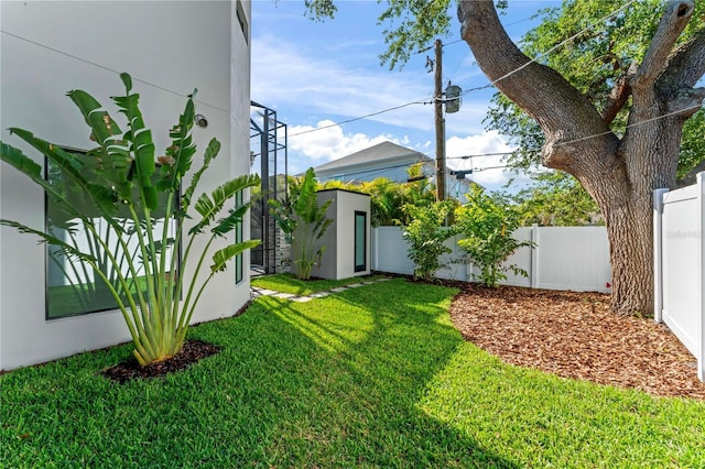 view of yard featuring an outdoor structure and fence