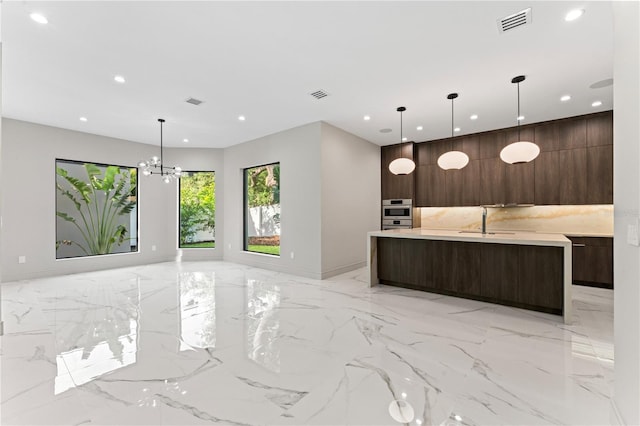 kitchen with modern cabinets, visible vents, light countertops, and dark brown cabinetry