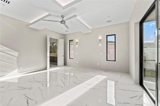 spare room with baseboards, marble finish floor, ceiling fan, and visible vents