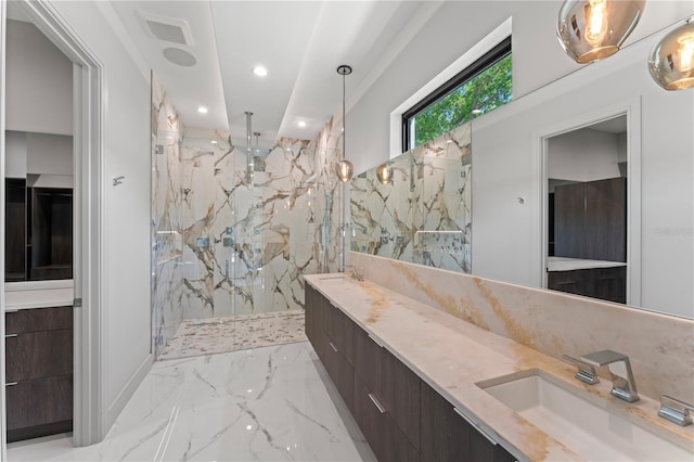 bathroom with marble finish floor, a sink, a marble finish shower, and double vanity
