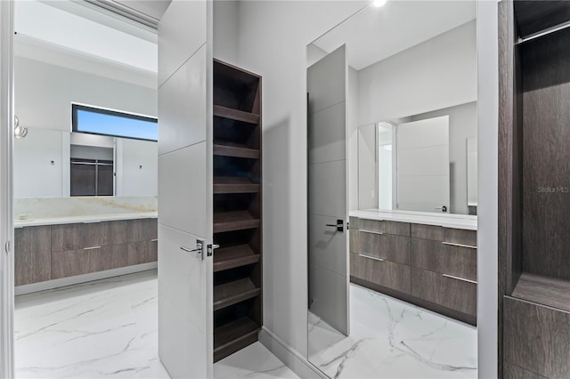 bathroom with marble finish floor and vanity
