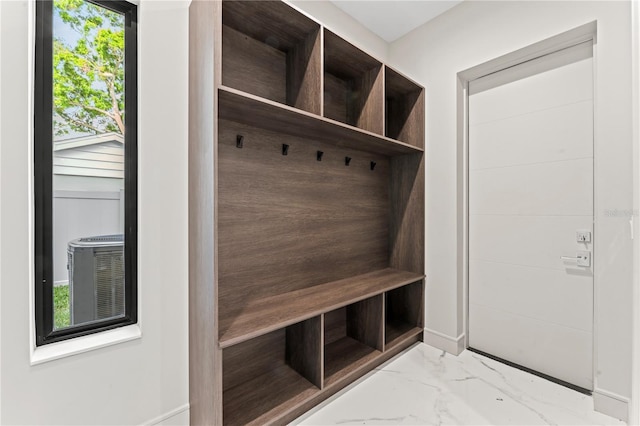 mudroom featuring marble finish floor and baseboards