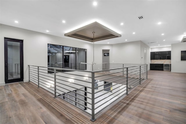 hall featuring visible vents, recessed lighting, and wood finished floors