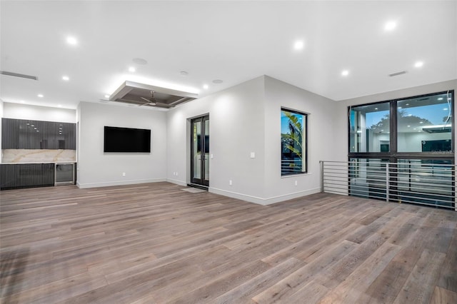 unfurnished living room with light wood-type flooring, visible vents, recessed lighting, and a ceiling fan