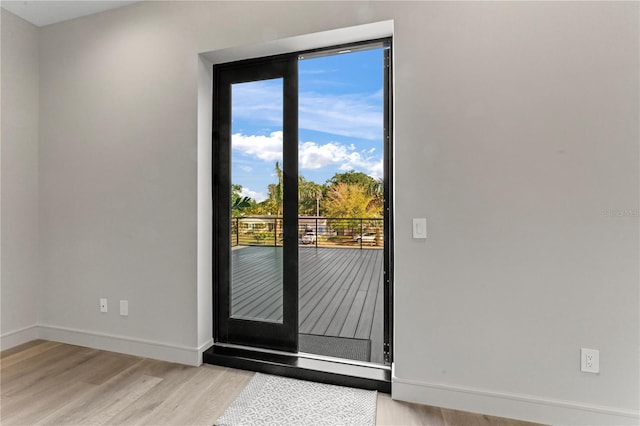 entryway featuring light wood-style flooring and baseboards