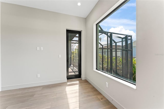 spare room featuring recessed lighting, baseboards, and wood finished floors