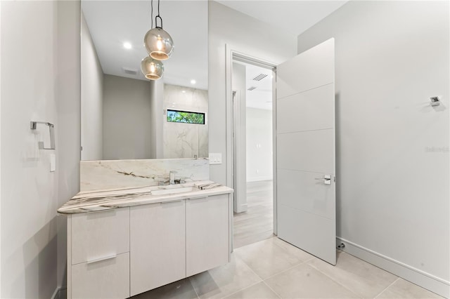 bathroom featuring tile patterned flooring, vanity, and baseboards