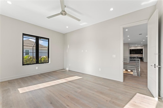 empty room featuring baseboards, light wood-style flooring, ceiling fan, and recessed lighting