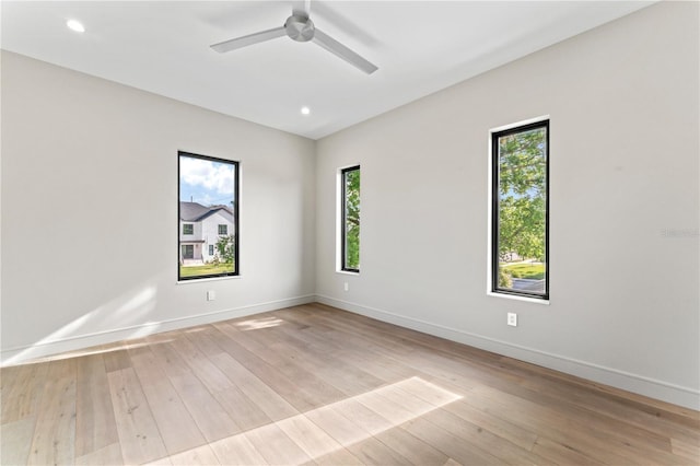 unfurnished room with baseboards, light wood-style floors, and ceiling fan
