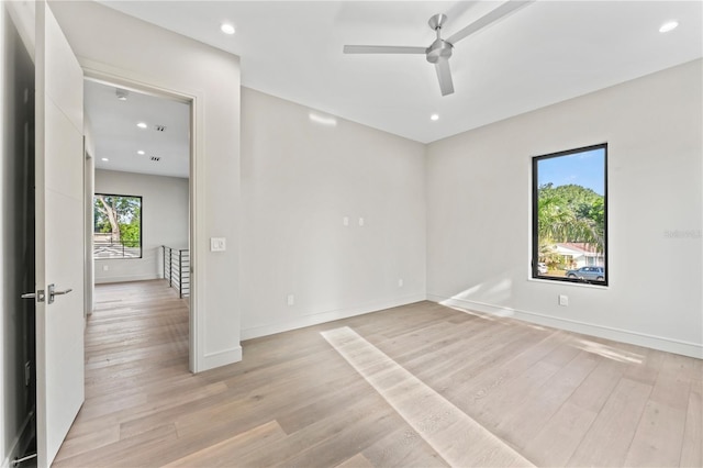 spare room featuring baseboards, light wood-style floors, recessed lighting, and a ceiling fan