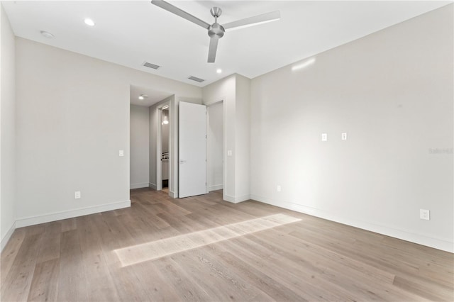unfurnished bedroom with light wood finished floors, baseboards, and visible vents