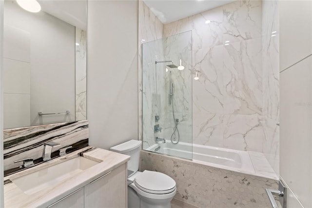 bathroom featuring a combined bath / shower with marble appearance, toilet, and vanity