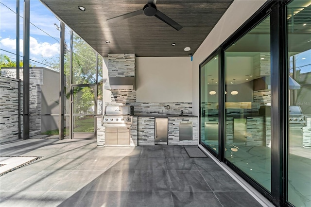 view of patio with glass enclosure, grilling area, area for grilling, and a ceiling fan
