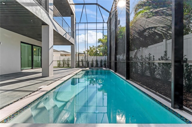 view of pool featuring fence, a lanai, a patio area, and a fenced in pool