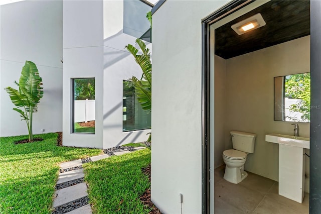 bathroom with toilet and tile patterned flooring