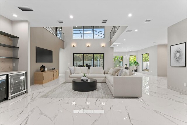 3604 W El Prado Blvd, Tampa, FL 33629 - living room with beverage cooler, light marble finish flooring, a skylight, recessed lighting, and baseboards