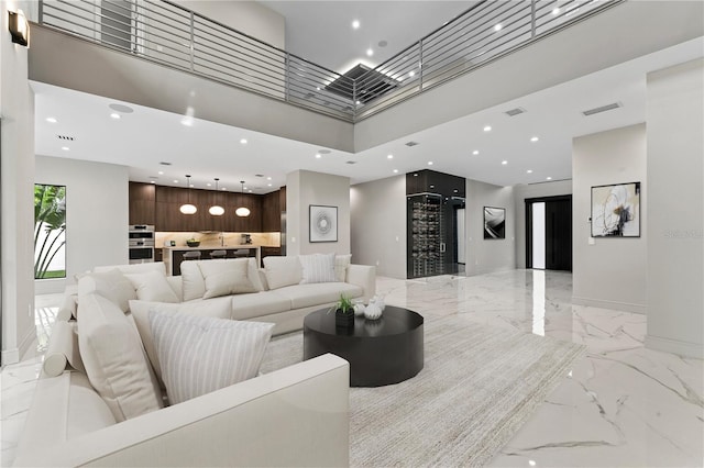 3604 W El Prado Blvd, Tampa, FL 33629 - living room with light marble finish floors, a high ceiling, recessed lighting, and baseboards