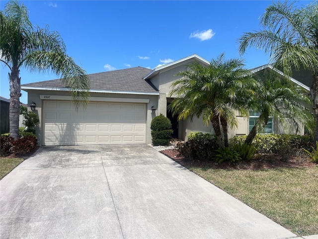 ranch-style house featuring stucco siding, driveway, and an attached garage