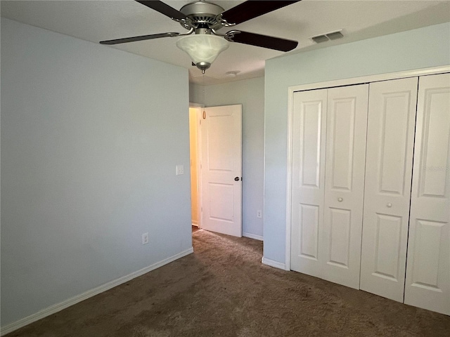 unfurnished bedroom with carpet flooring, a closet, baseboards, and ceiling fan
