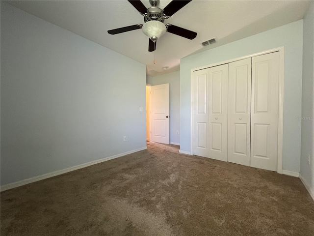 unfurnished bedroom featuring carpet, baseboards, a closet, and ceiling fan
