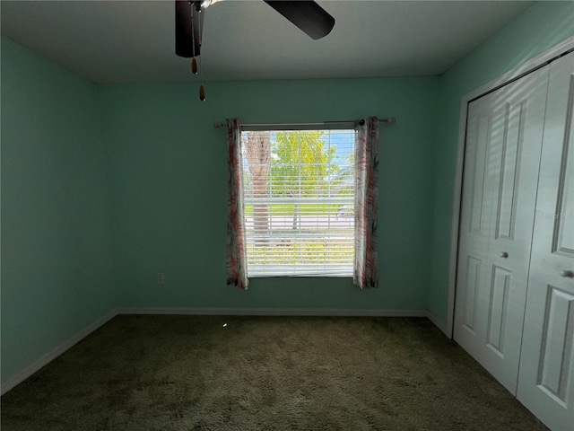 unfurnished bedroom featuring carpet flooring, a closet, baseboards, and ceiling fan