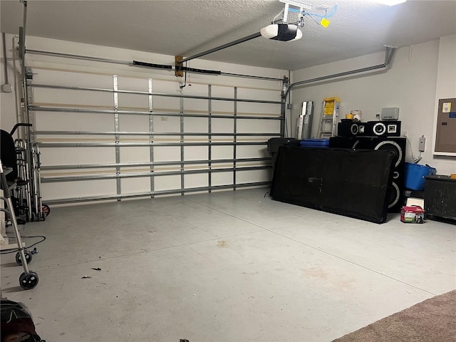 garage with a garage door opener and electric panel
