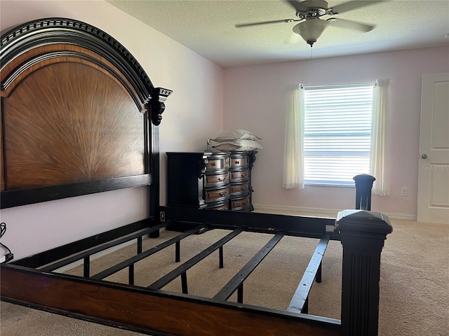 office area with carpet flooring, ceiling fan, and a textured ceiling
